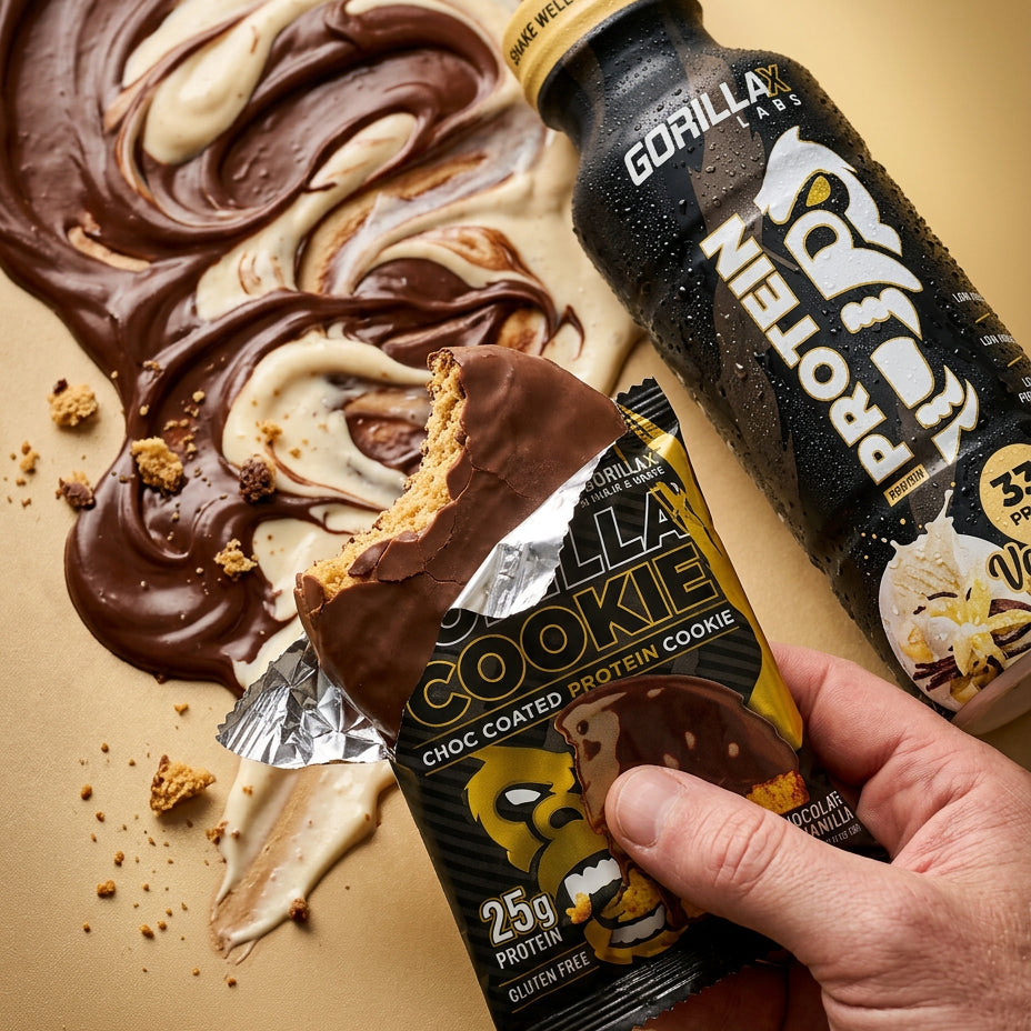 Hand holding a protein cookie and a bottle of Gorilla Protein on a beige background