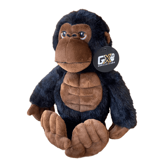 A plush toy resembling a brown gorilla with a GX Labs tag on its neck.